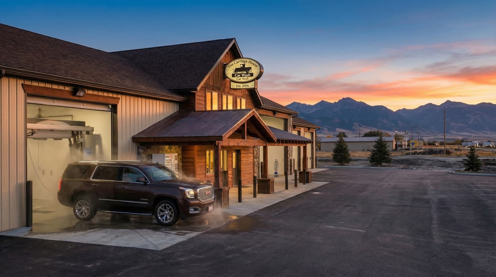 SUV exiting the automatic touch-free wash bay at sunset
